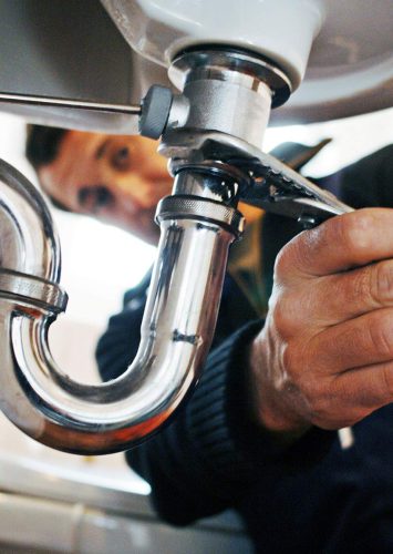 close-up-of-plumber-repairing-sink-with-tool-in-ba-2025-02-04-02-12-53-9XBKELG.jpg